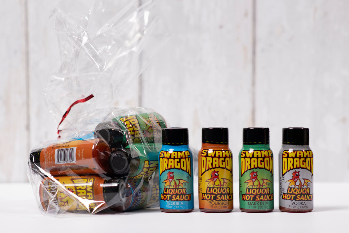 A clear cellophane bag filled with one ounce bottles of Swamp Dragon Hot Sauce
