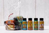 A clear cellophane bag filled with one ounce bottles of Swamp Dragon Hot Sauce